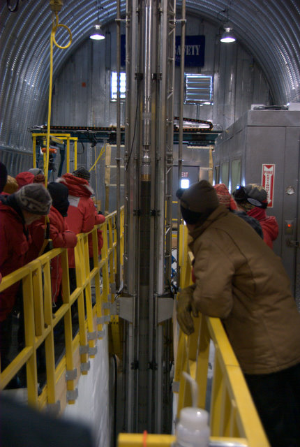 Everyone gathers about the "slot" to watch drill